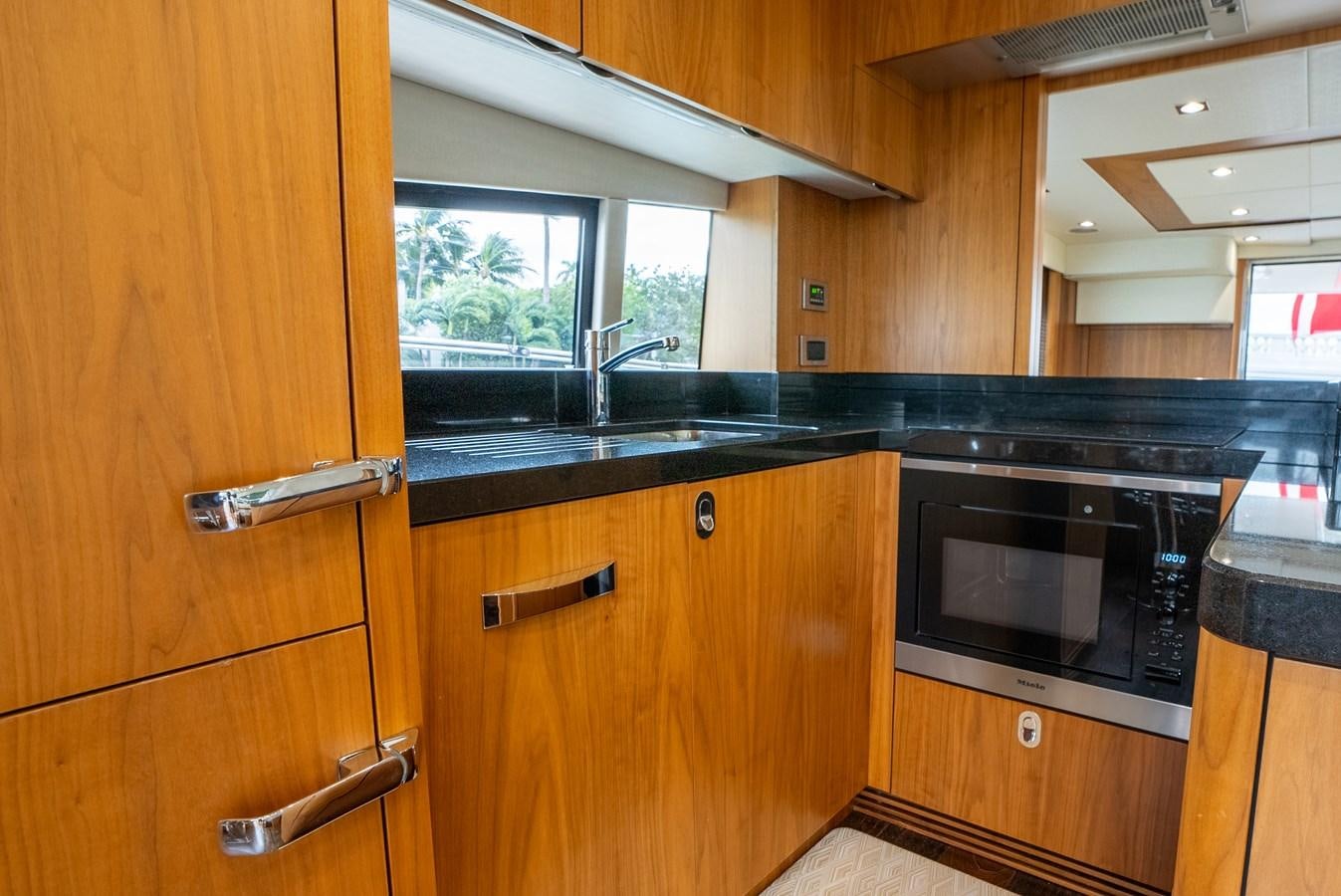 a kitchen with wooden cabinets aboard SHANTI Yacht for Sale