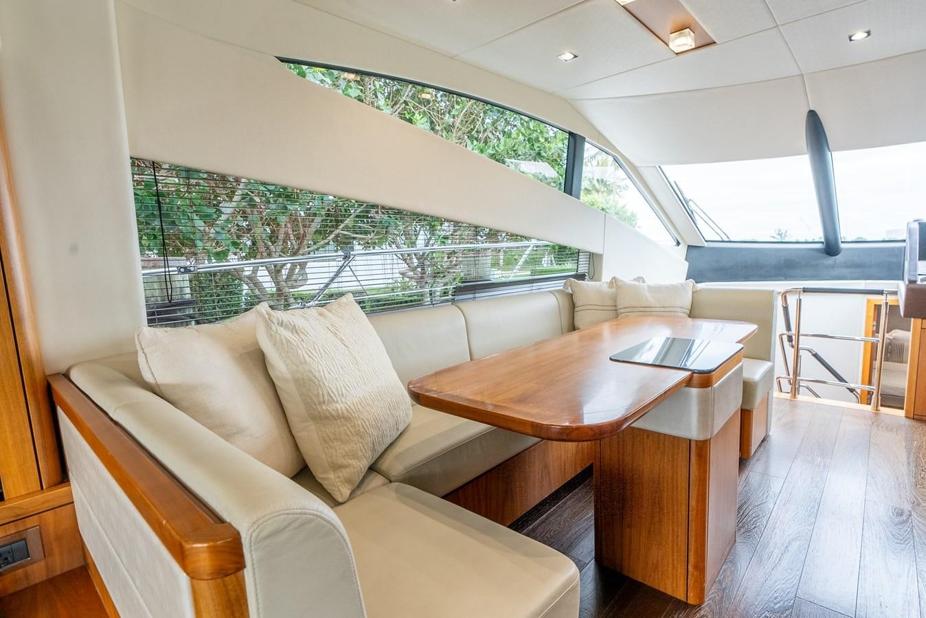 a living room with a table and couches aboard SHANTI Yacht for Sale