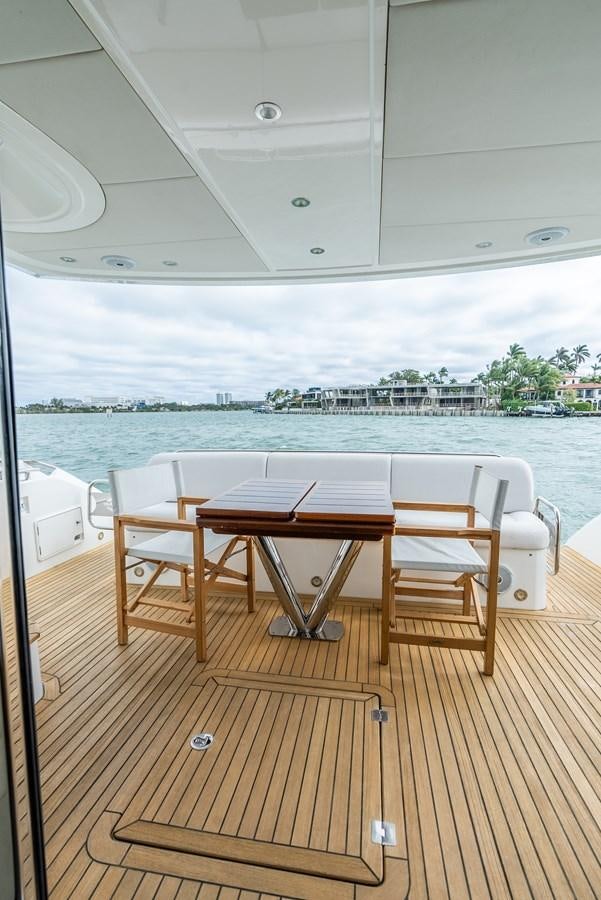a table and chairs on a deck aboard SHANTI Yacht for Sale