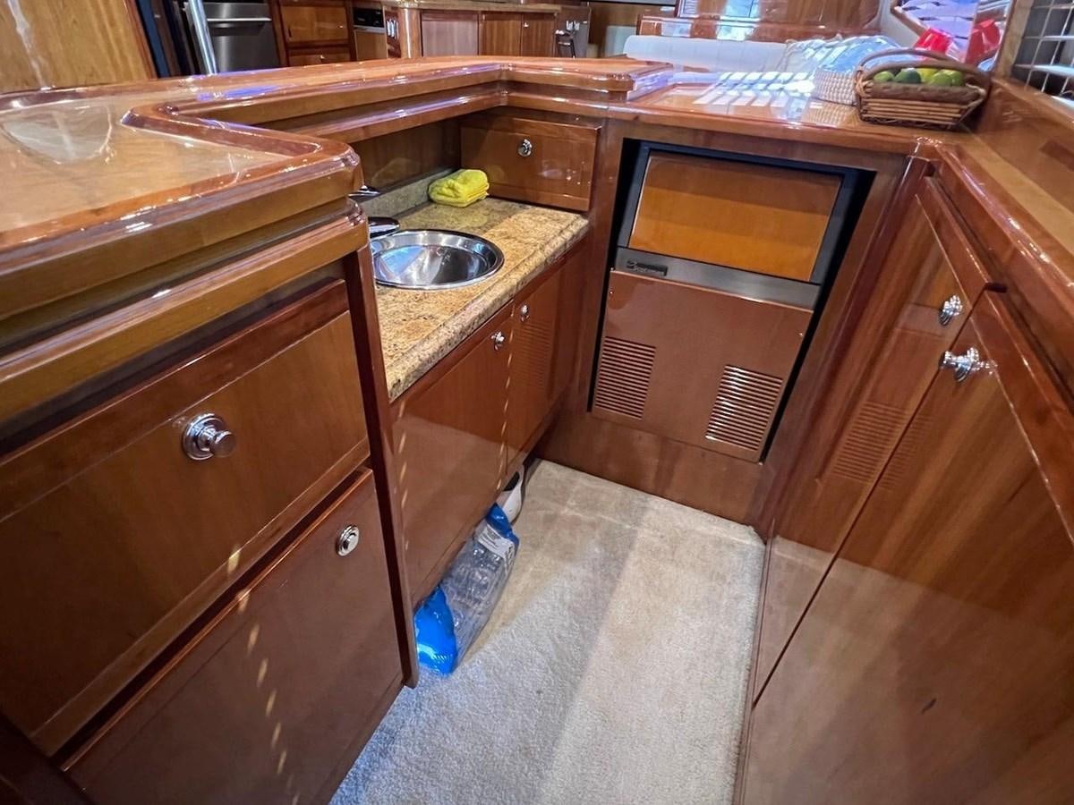 a kitchen with wooden cabinets aboard BEACH BUM Yacht for Sale