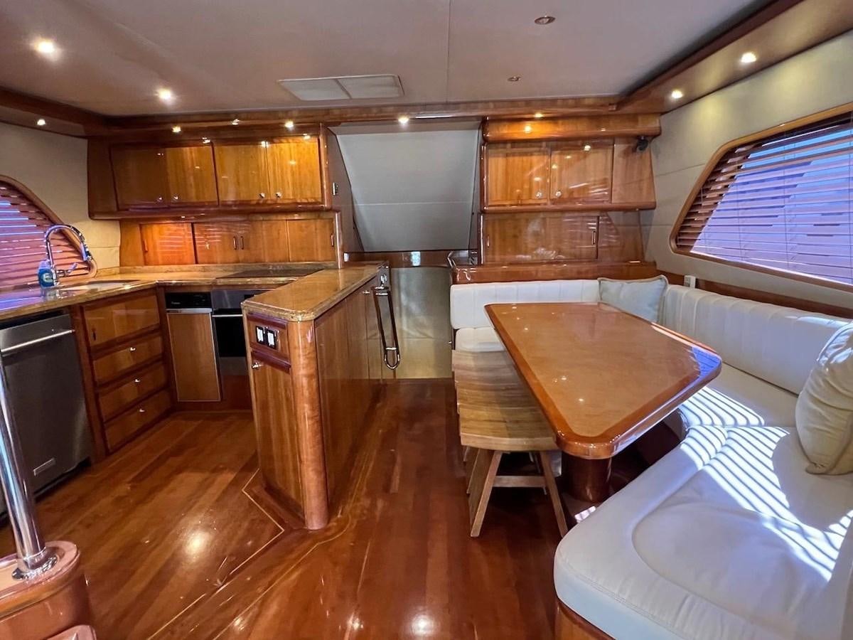 a kitchen with wooden cabinets aboard BEACH BUM Yacht for Sale