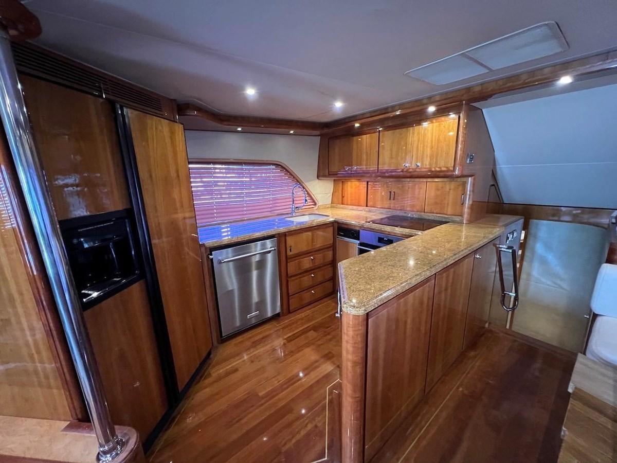 a kitchen with wooden cabinets aboard BEACH BUM Yacht for Sale