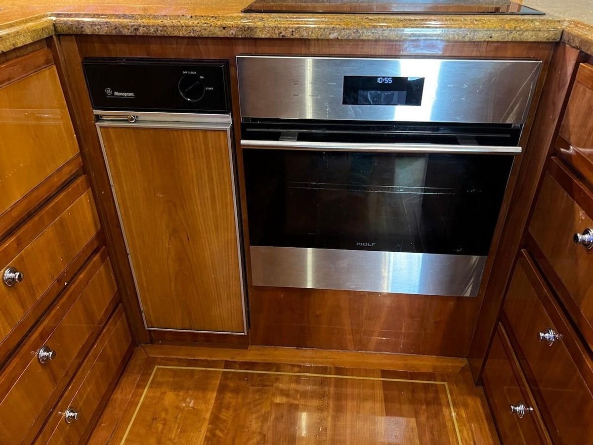 a kitchen with wooden cabinets aboard BEACH BUM Yacht for Sale