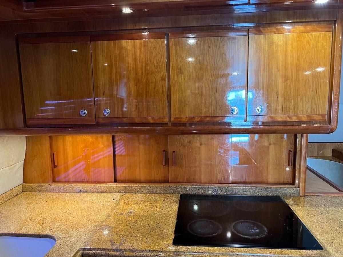 a kitchen with wooden cabinets aboard BEACH BUM Yacht for Sale