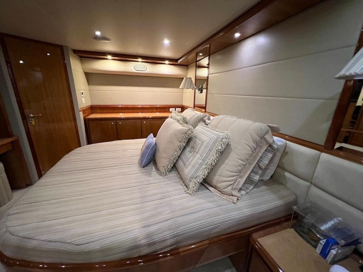 a bed with white sheets aboard BEACH BUM Yacht for Sale