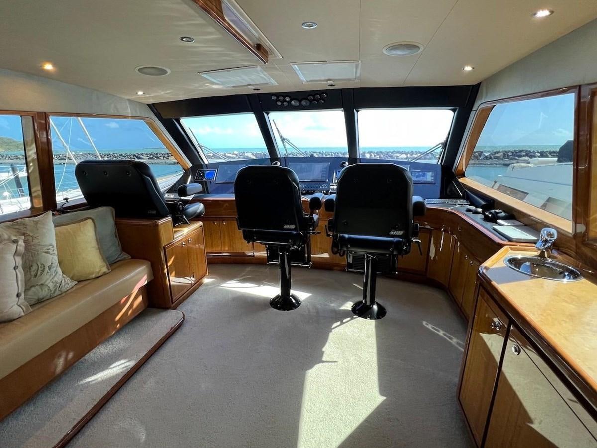 a room with a couch and a desk and a tv aboard BEACH BUM Yacht for Sale