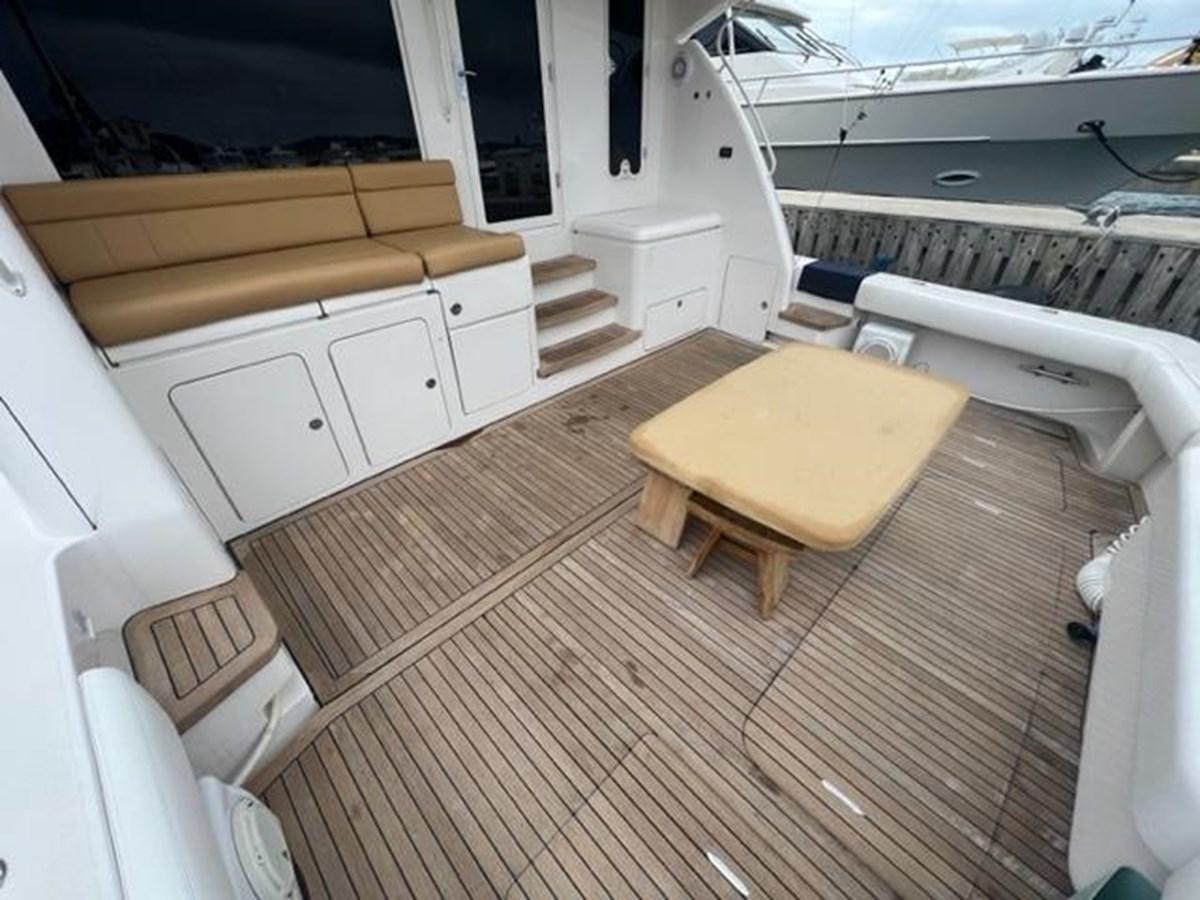 a room with a bed and a table aboard BEACH BUM Yacht for Sale