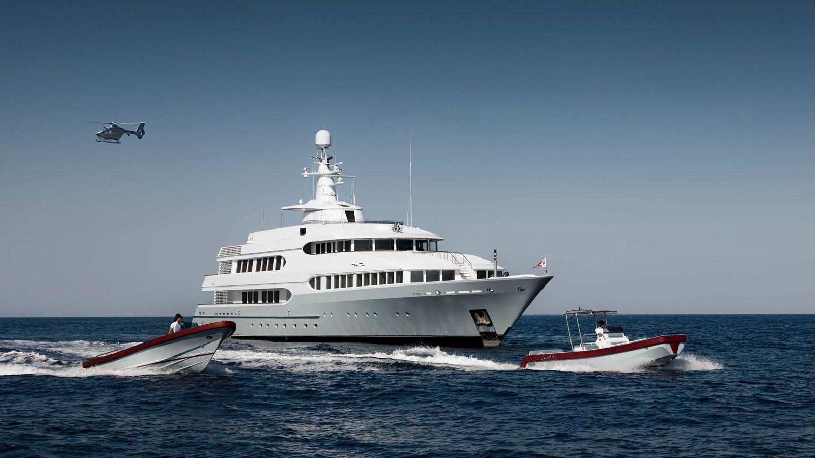 a helicopter flying over a boat aboard OLYMPUS Yacht for Sale