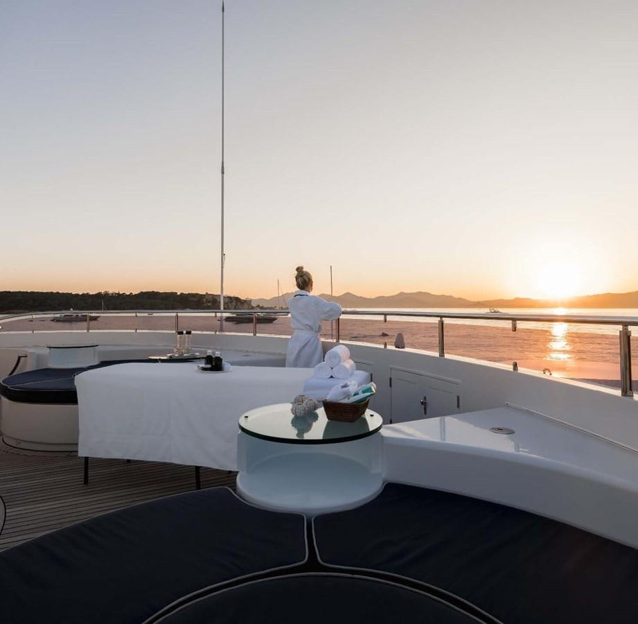 a person sitting on a table aboard OLYMPUS Yacht for Sale
