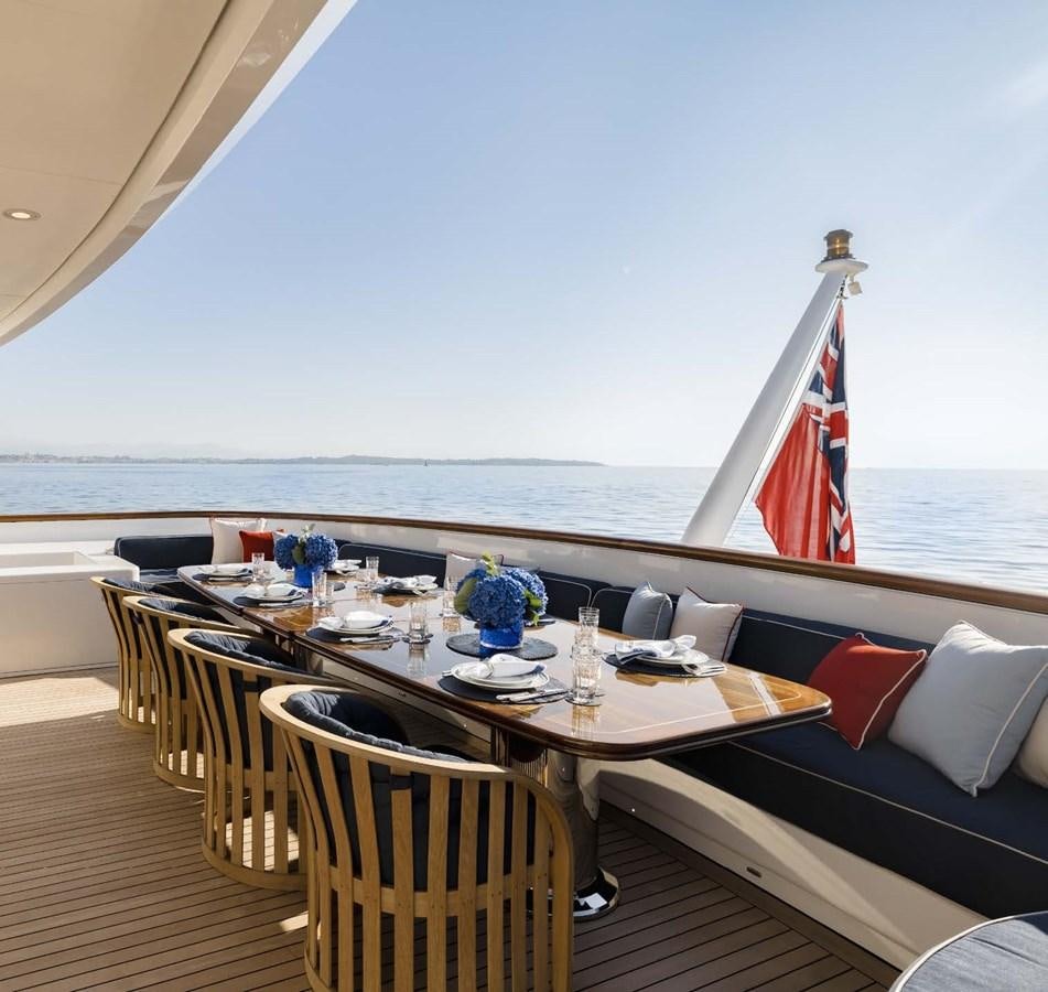 a table with chairs on it aboard OLYMPUS Yacht for Sale