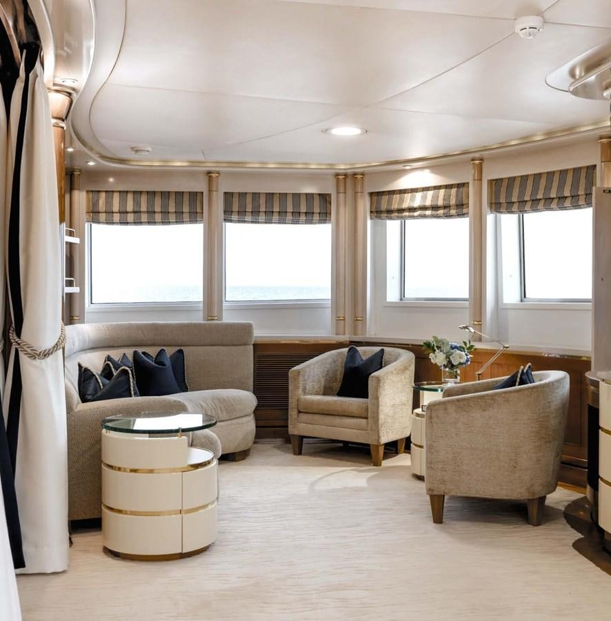 a living room with a couch and a table aboard OLYMPUS Yacht for Sale