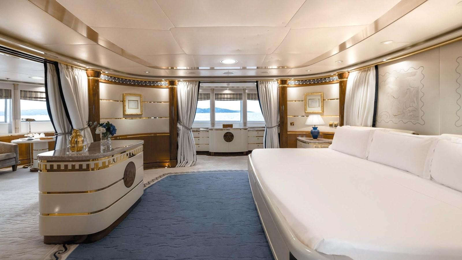 a room with a bed and a blue rug aboard OLYMPUS Yacht for Sale