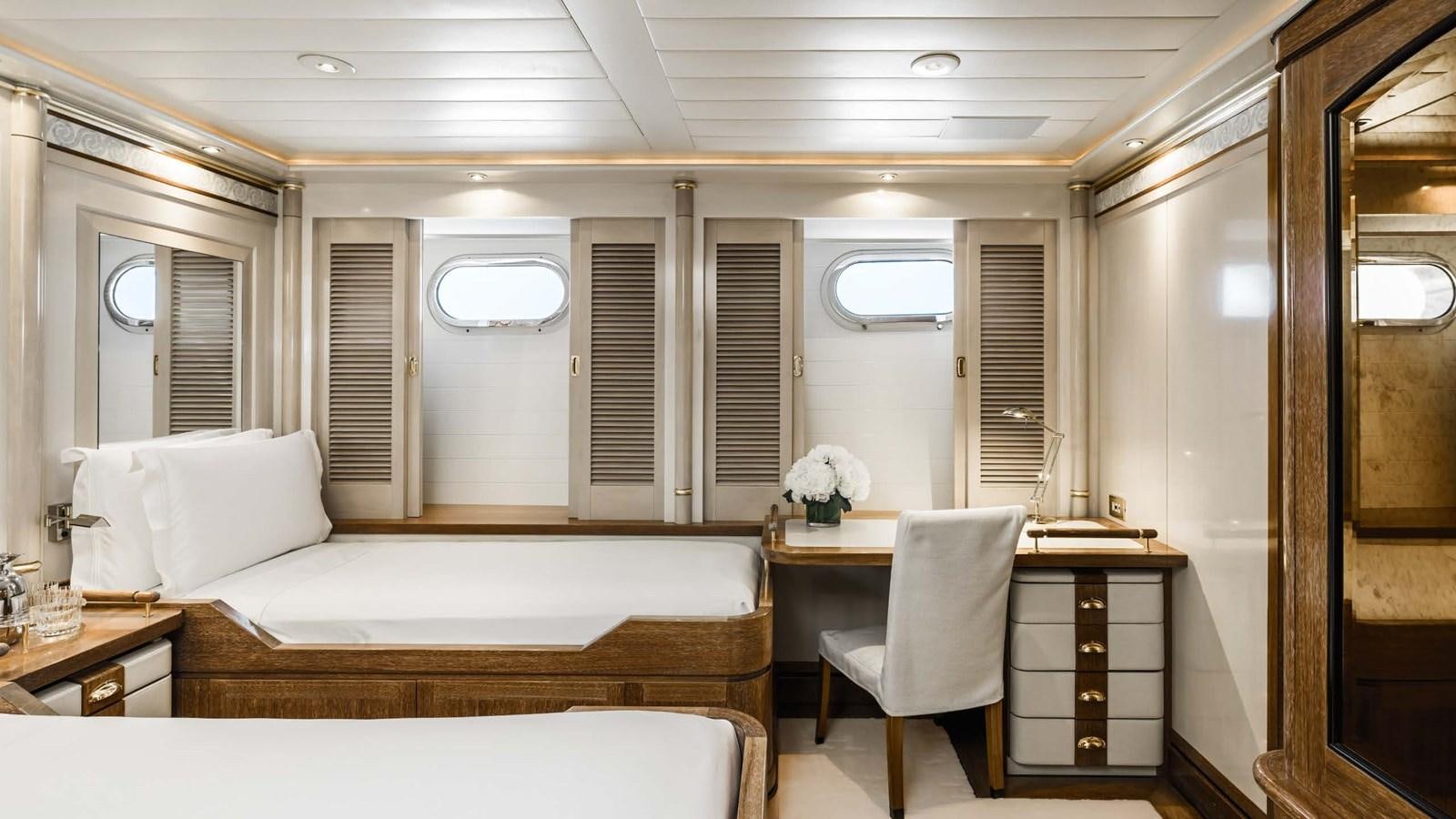 a room with a bed and a desk aboard OLYMPUS Yacht for Sale