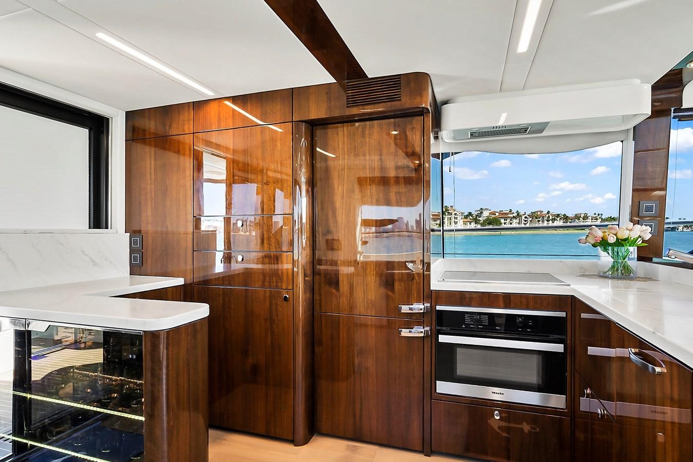 a kitchen with wooden cabinets aboard RAW WAVE Yacht for Sale