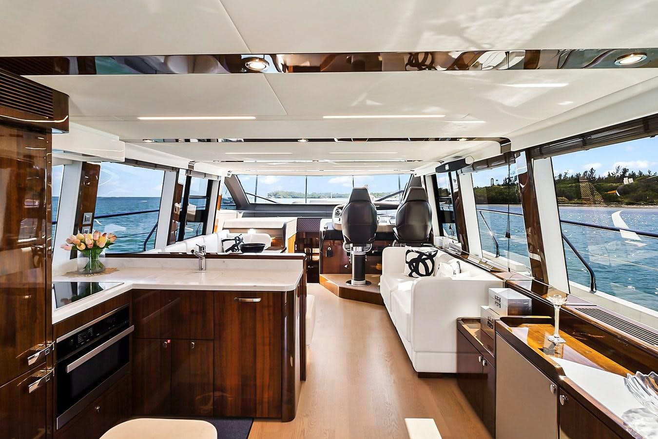 a room with a large window and a desk with a chair aboard RAW WAVE Yacht for Sale
