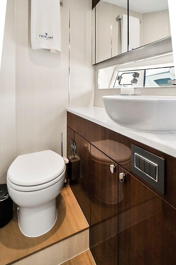 a bathroom with a toilet and sink aboard RAW WAVE Yacht for Sale