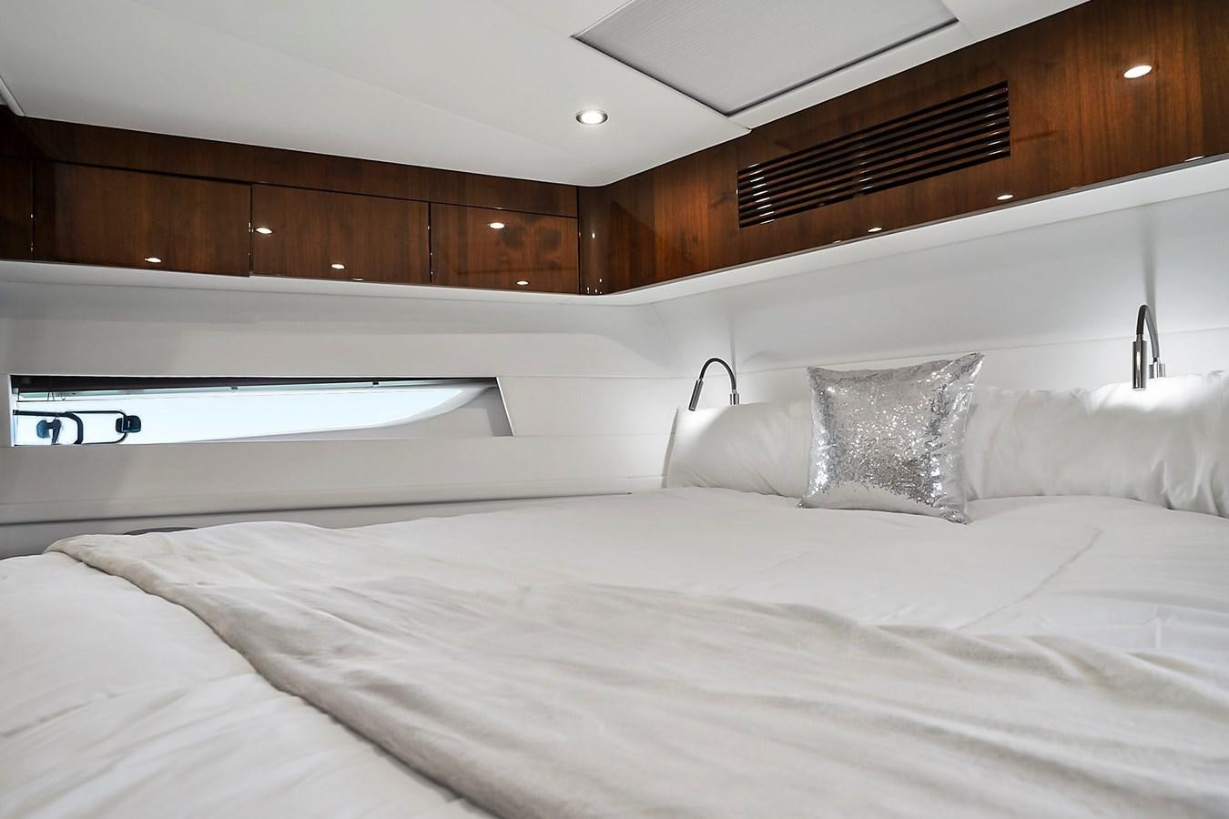 a bed with white sheets aboard RAW WAVE Yacht for Sale