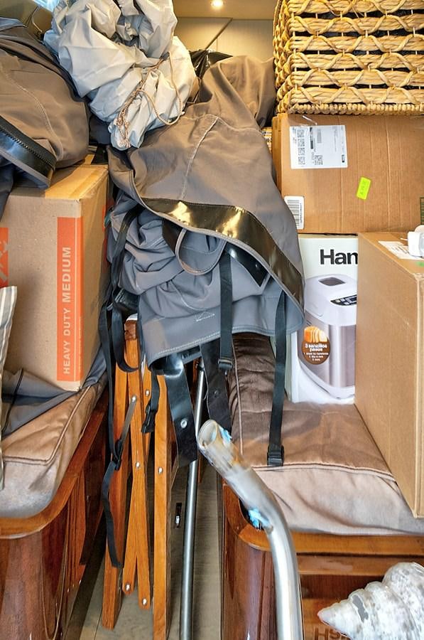 a pile of clothes and boxes aboard RAW WAVE Yacht for Sale