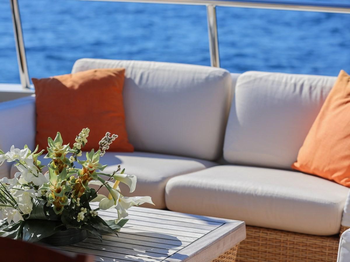 a white couch with orange pillows aboard BANDIDO I Yacht for Sale