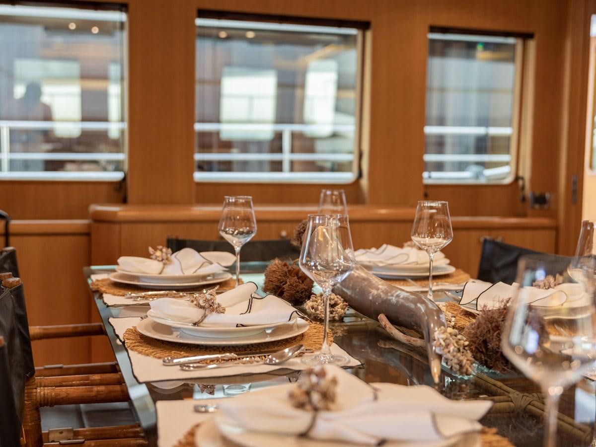 a table with plates and glasses aboard BANDIDO I Yacht for Sale