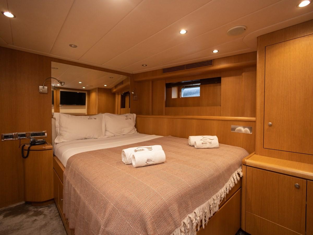 a room with a bed and a closet aboard BANDIDO I Yacht for Sale