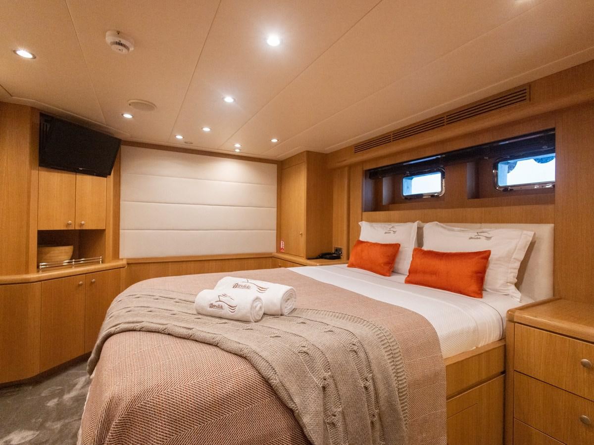a hotel room with a bed and tv aboard BANDIDO I Yacht for Sale