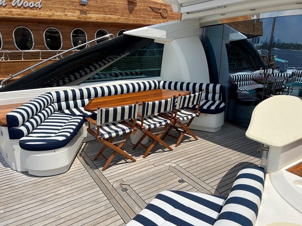 a deck with chairs and a table aboard SUNSEEKER 95 PREDATOR Yacht for Sale