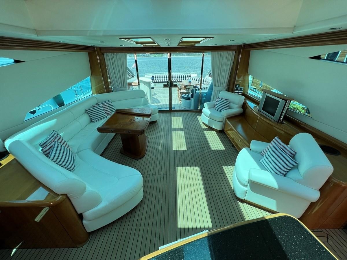 a room with a couch and chairs aboard SUNSEEKER 95 PREDATOR Yacht for Sale