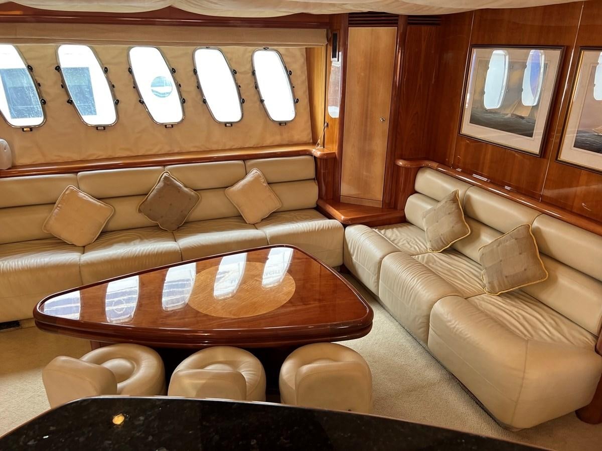 a room with a couch and a window aboard SUNSEEKER 95 PREDATOR Yacht for Sale