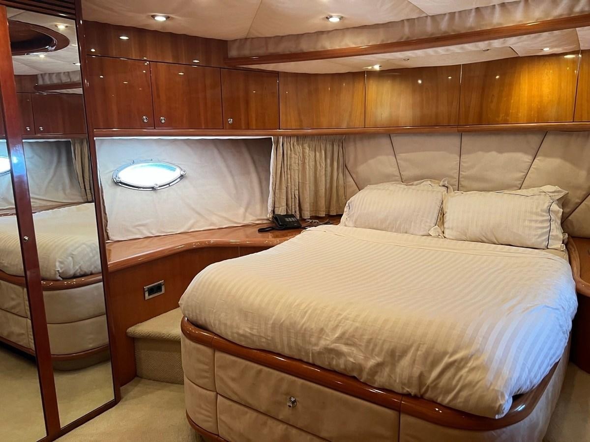 a bed with a white bed aboard SUNSEEKER 95 PREDATOR Yacht for Sale