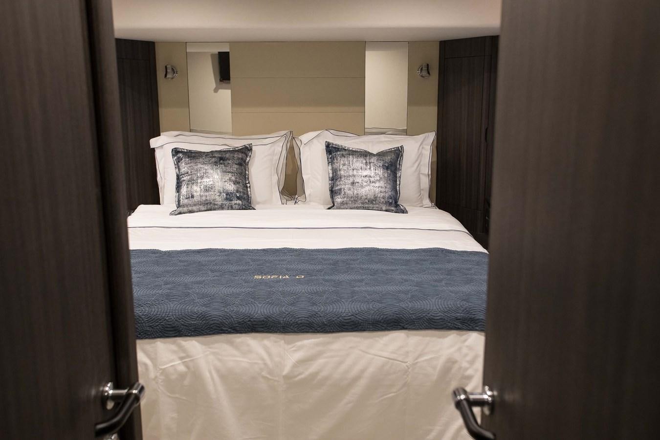 a bed with a blue blanket aboard SOFIA D Yacht for Sale