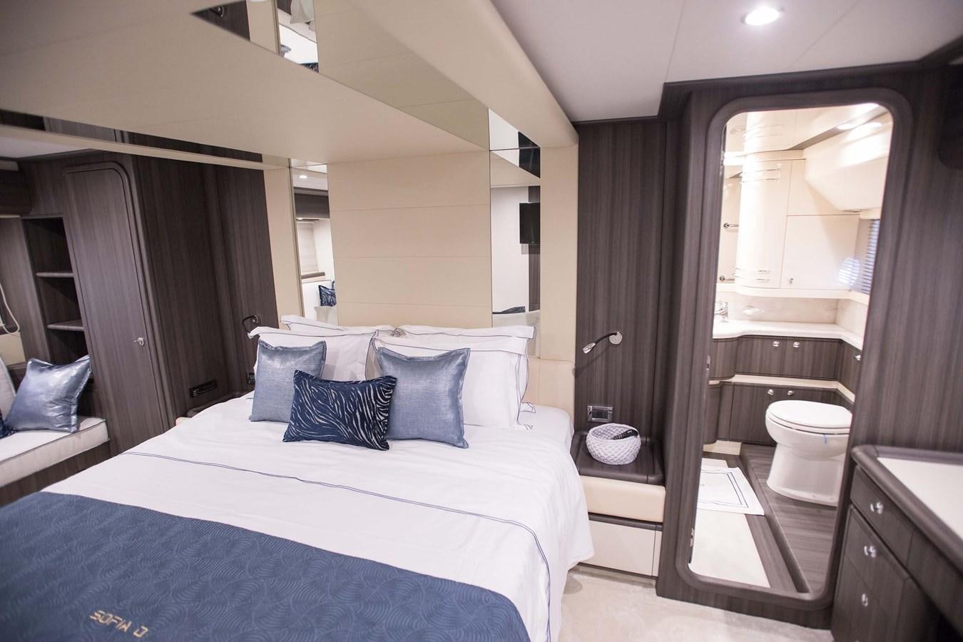 a bedroom with a bed and a mirror aboard SOFIA D Yacht for Sale