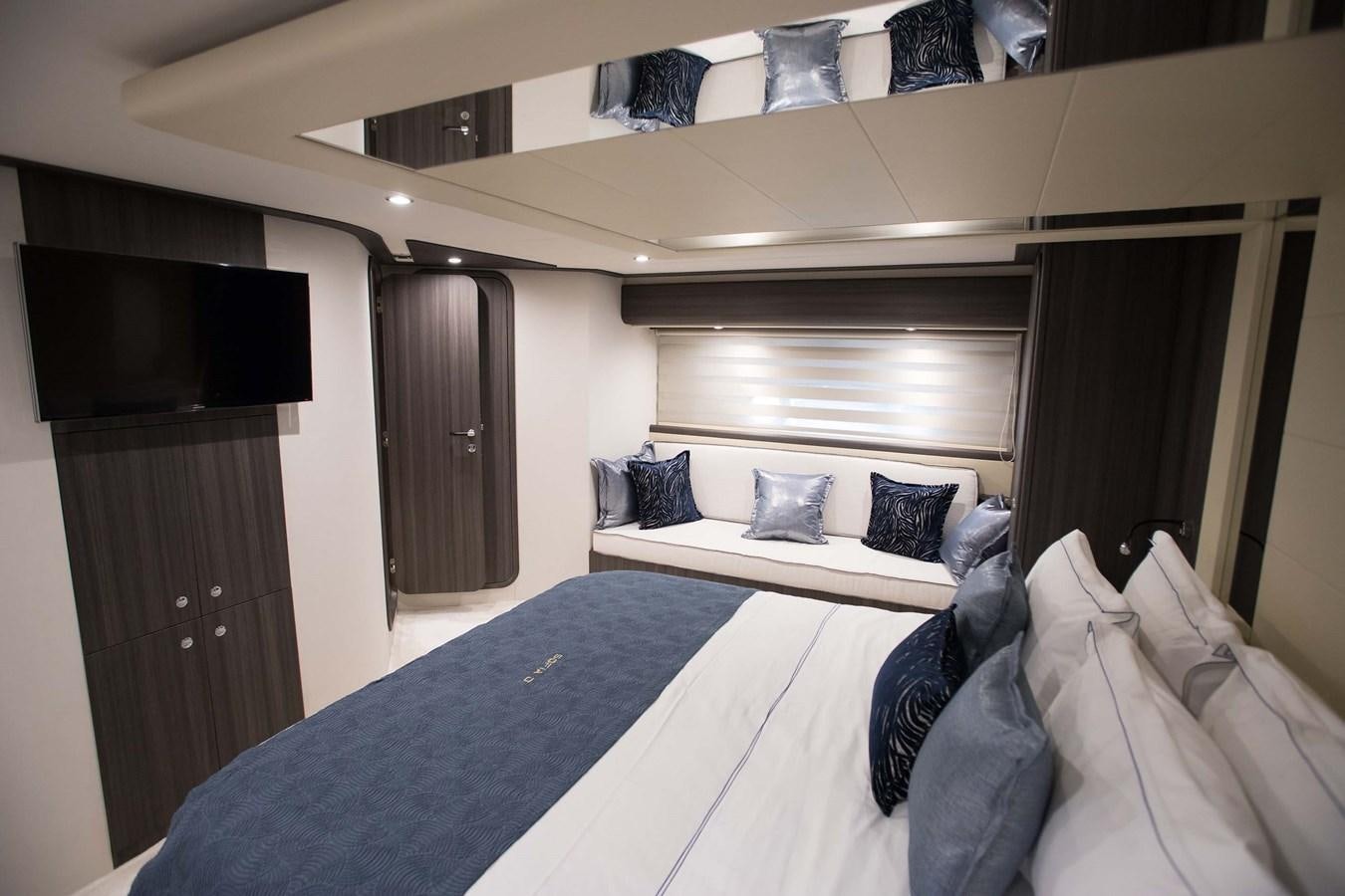 a bed with a blue sheet aboard SOFIA D Yacht for Sale