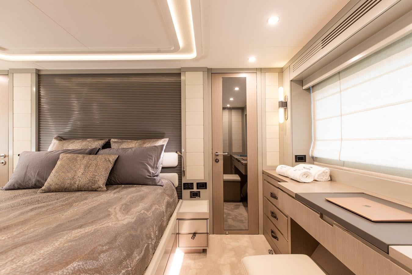 a bedroom with a bed and a desk aboard MY LADY Y Yacht for Sale
