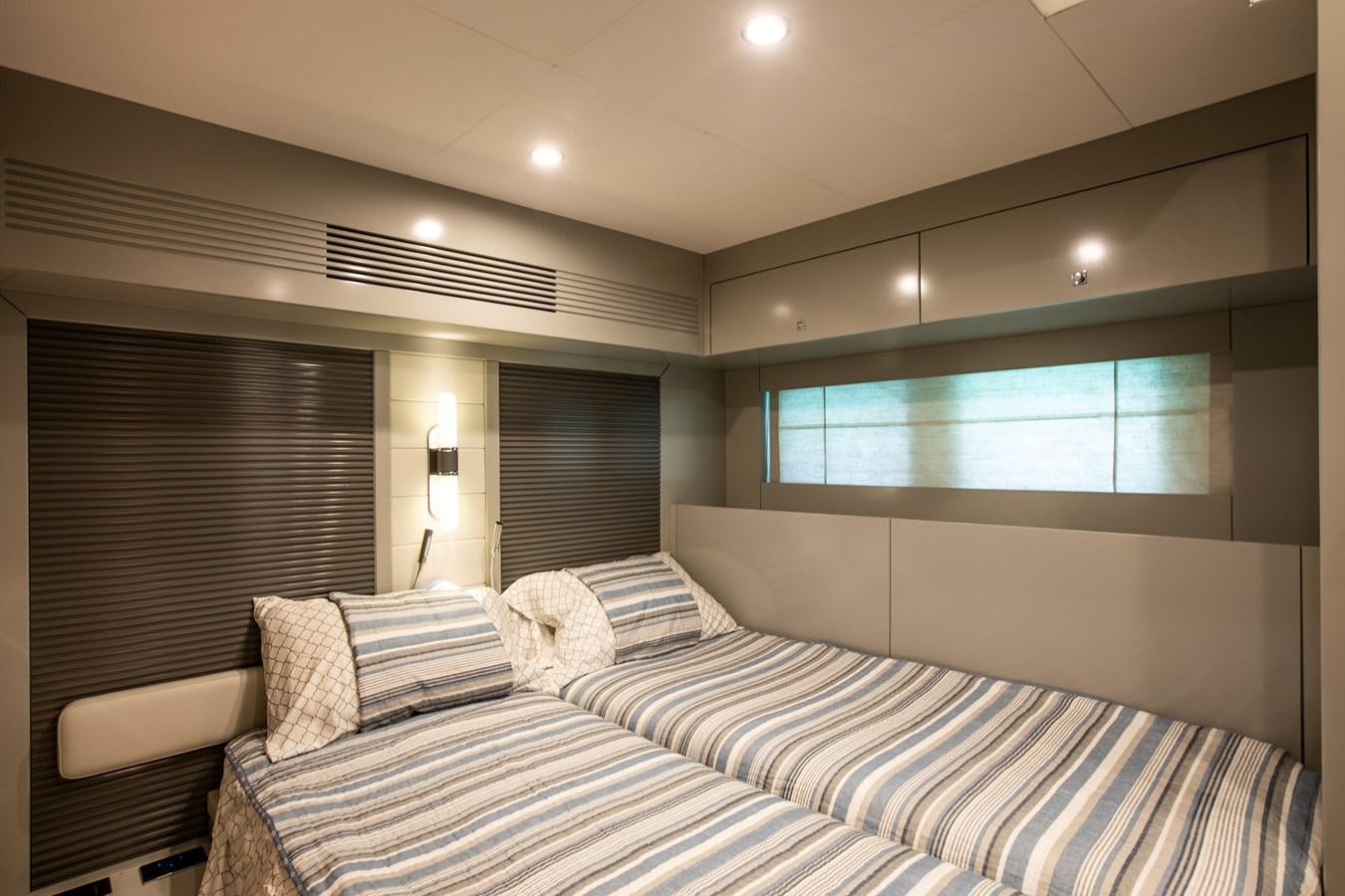 a bed with a striped blanket aboard MY LADY Y Yacht for Sale