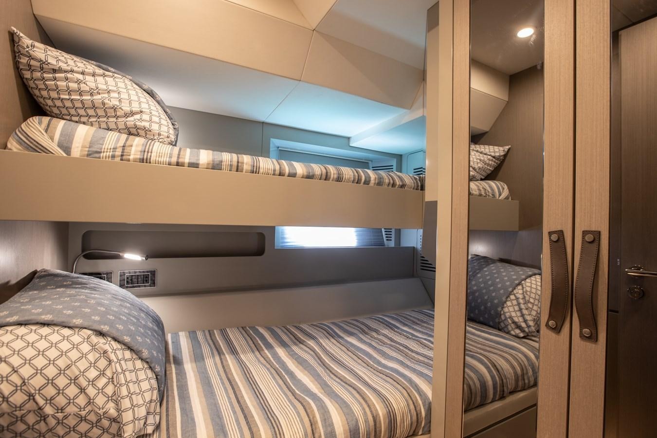 a bunk bed with a white bed aboard MY LADY Y Yacht for Sale
