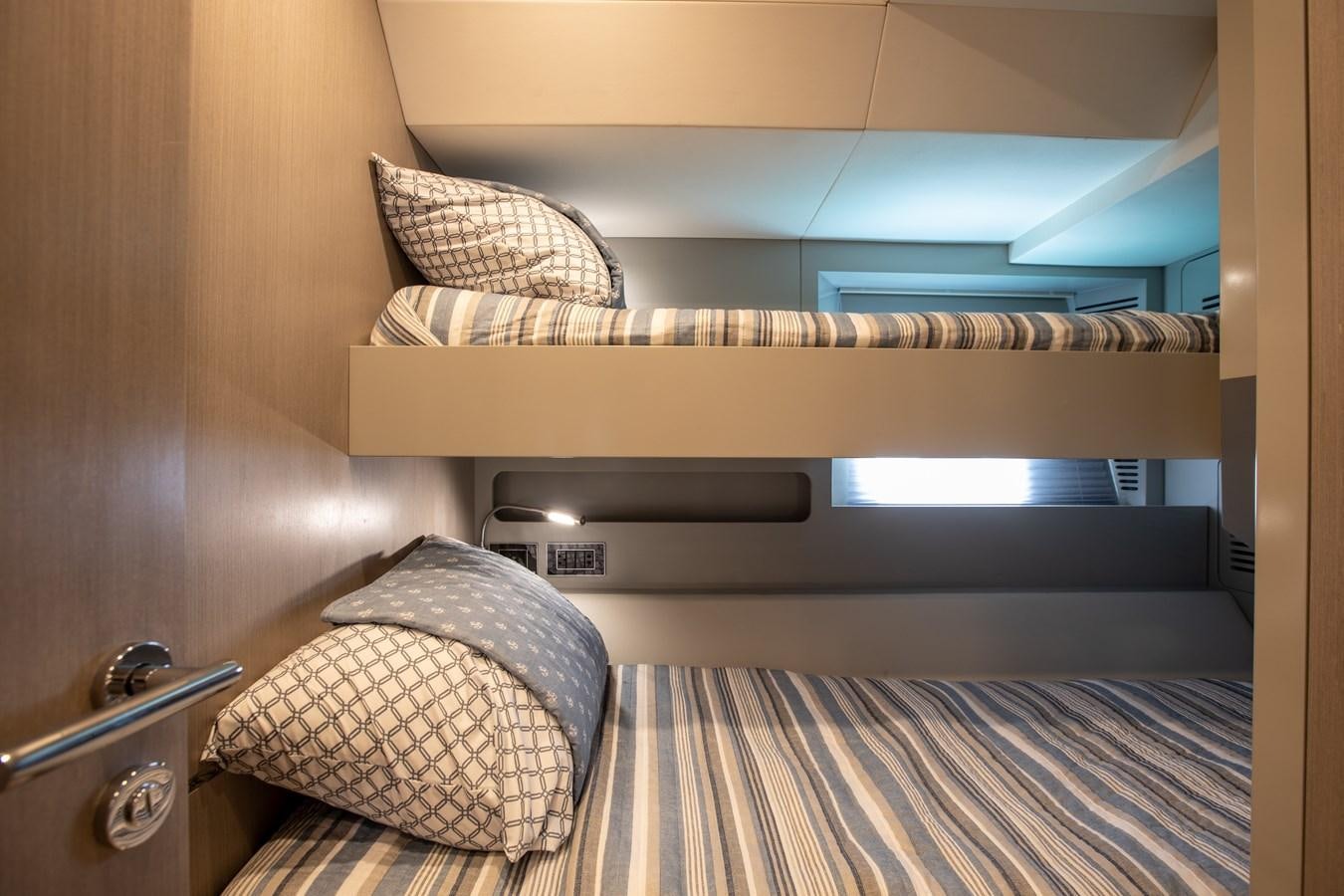a bed with a striped blanket aboard MY LADY Y Yacht for Sale