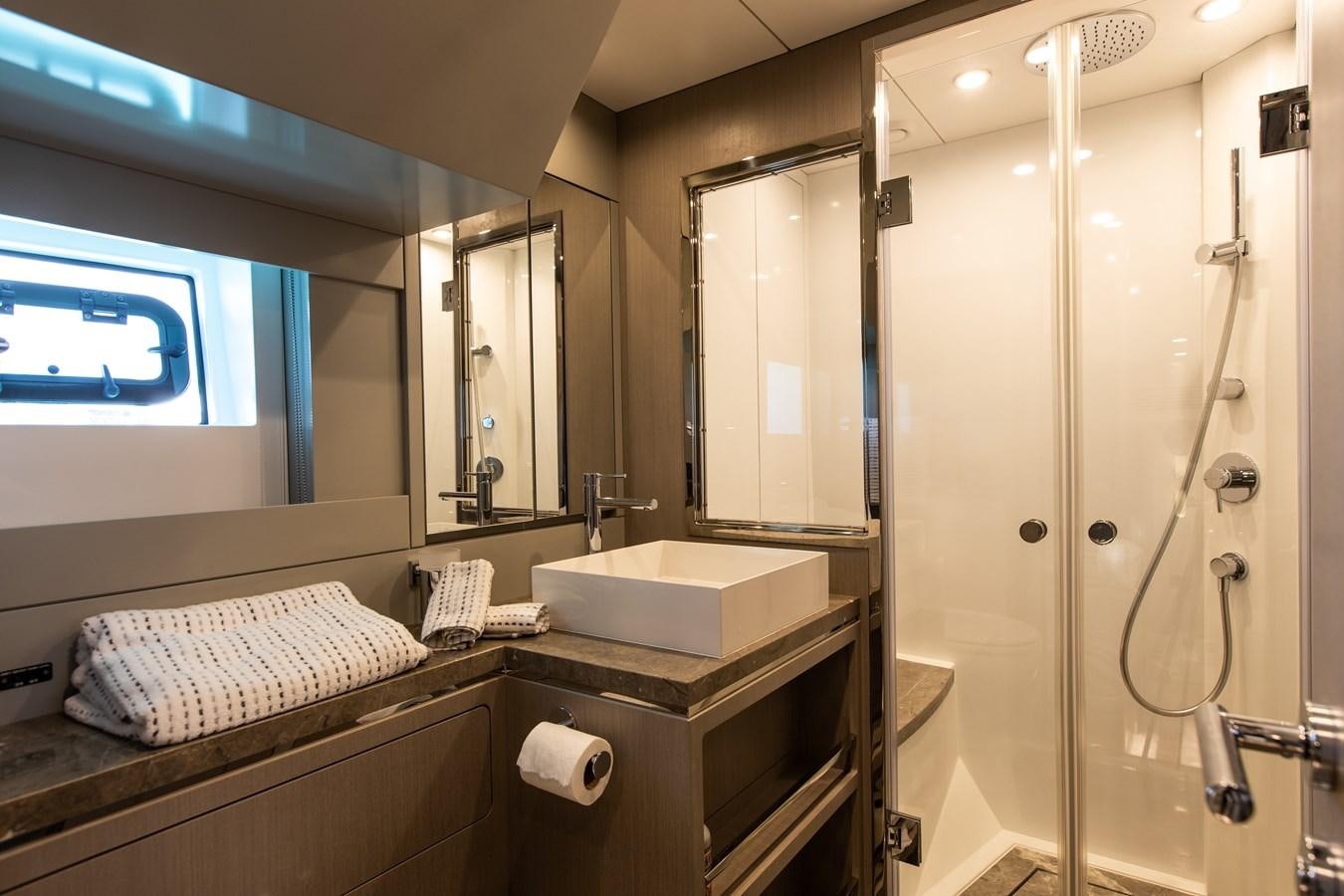 a bathroom with a glass shower aboard MY LADY Y Yacht for Sale
