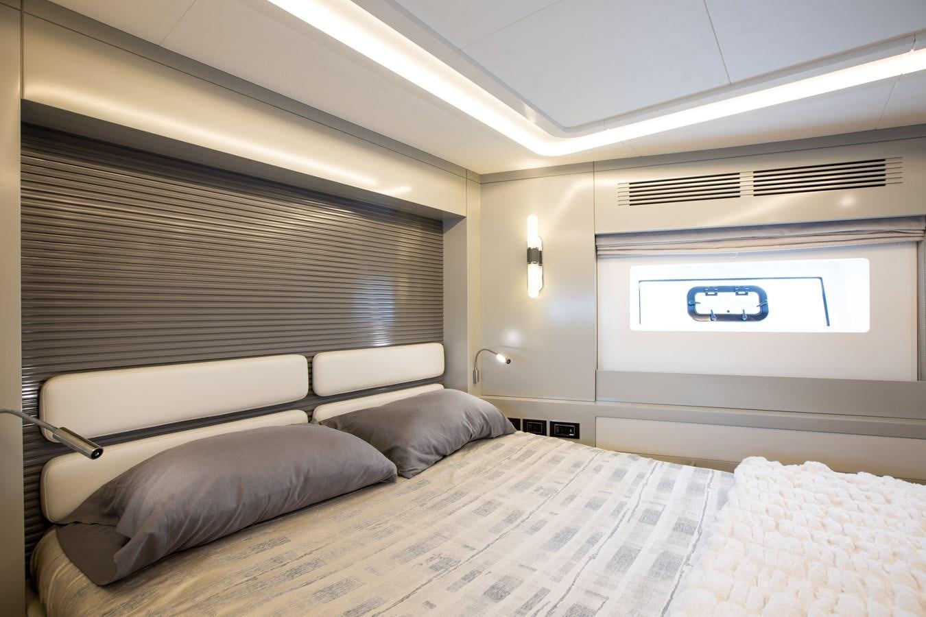 a bed with a white bed spread aboard MY LADY Y Yacht for Sale