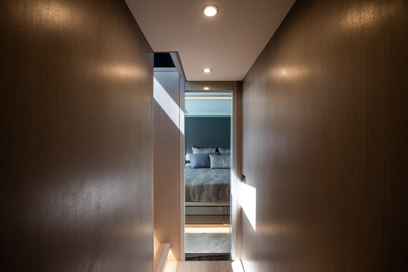 a hallway with a bed and a door aboard MY LADY Y Yacht for Sale