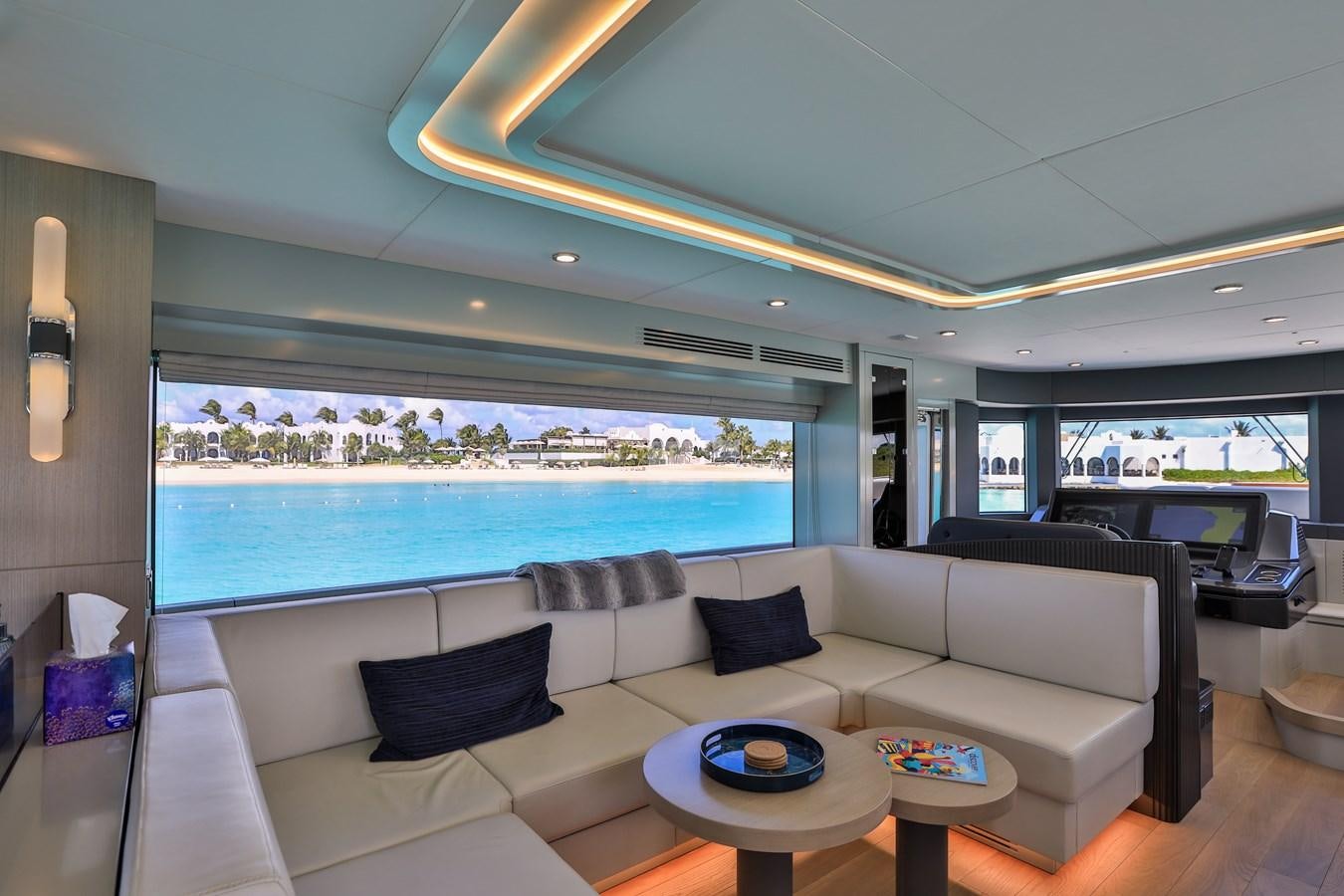 a living room with a large blue ocean aboard MY LADY Y Yacht for Sale