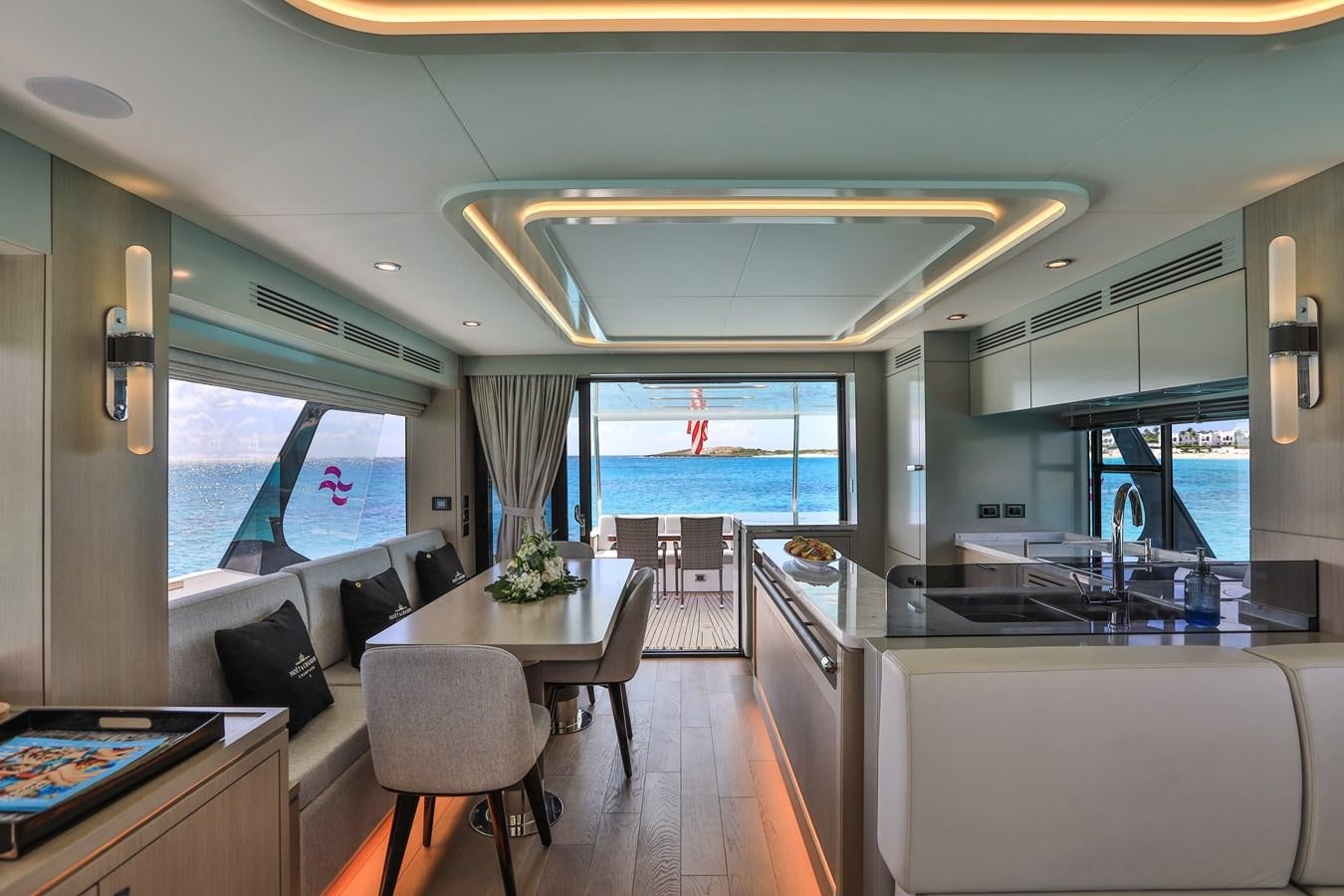 a room with a table chairs and a window aboard MY LADY Y Yacht for Sale