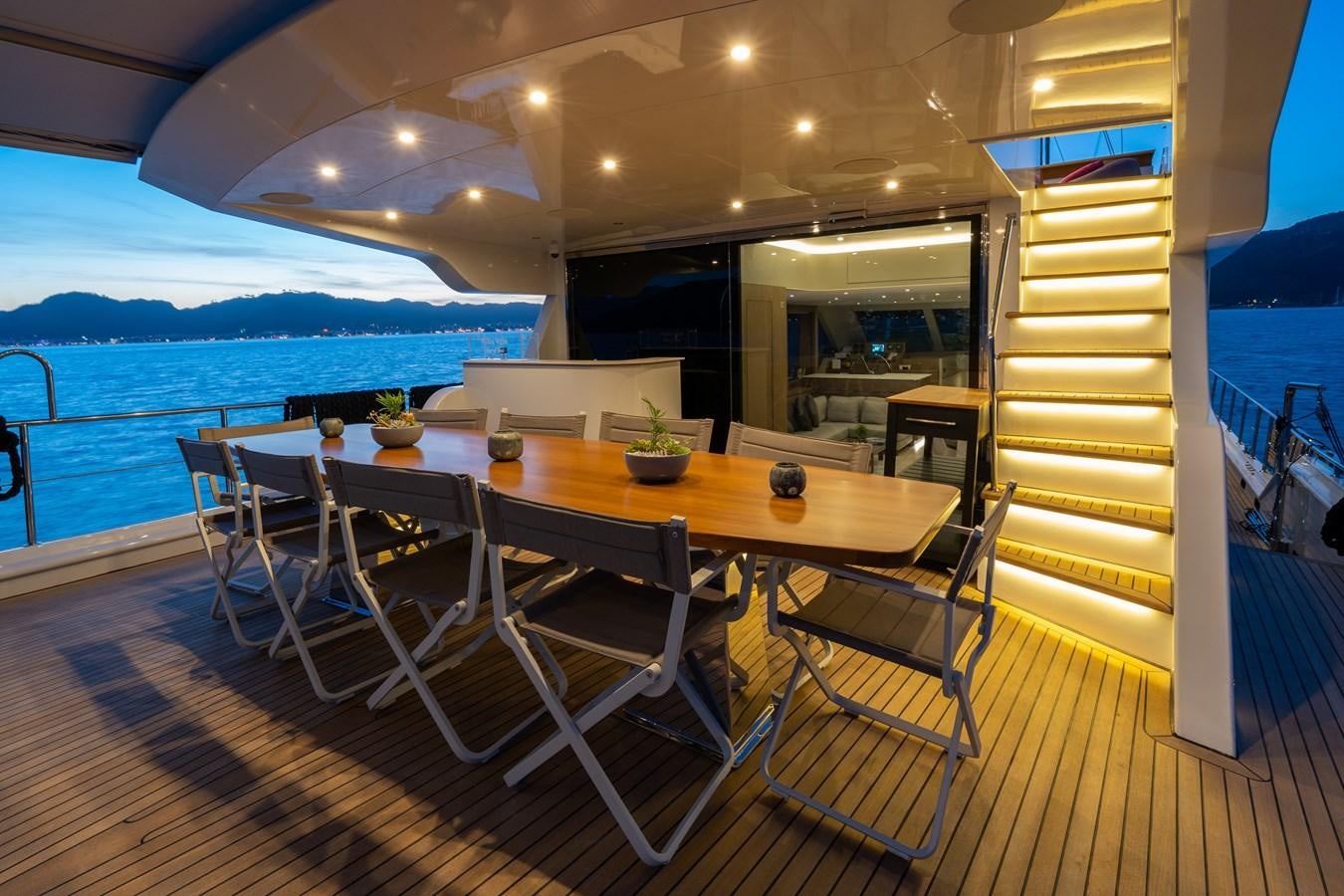 a table and chairs on a deck aboard PURA-VIDA Yacht for Sale