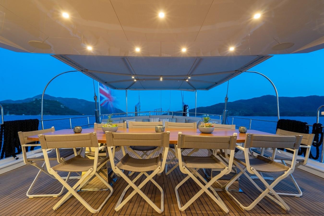 a table and chairs on a deck aboard PURA-VIDA Yacht for Sale