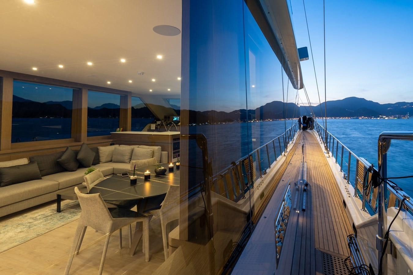 a balcony with a view of the ocean and mountains aboard PURA-VIDA Yacht for Sale