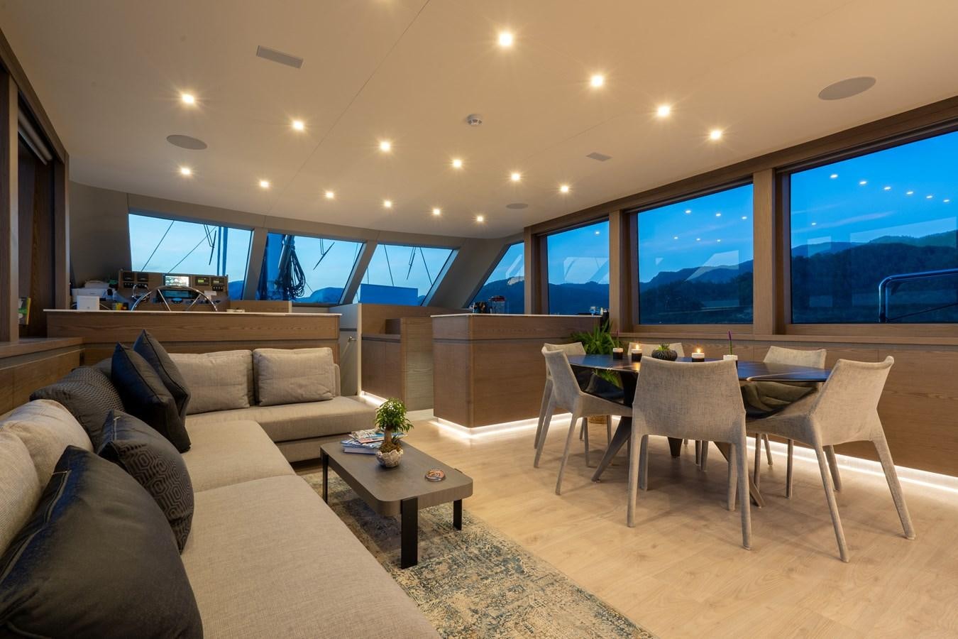 a living room with a large window aboard PURA-VIDA Yacht for Sale