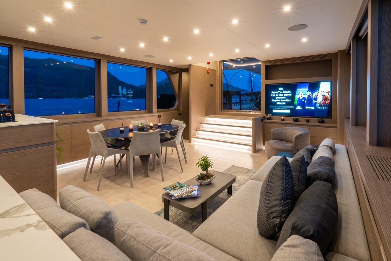 a living room with a large screen aboard PURA-VIDA Yacht for Sale