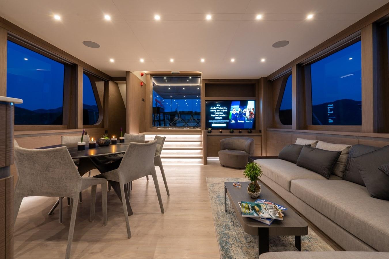 a living room with a large screen aboard PURA-VIDA Yacht for Sale