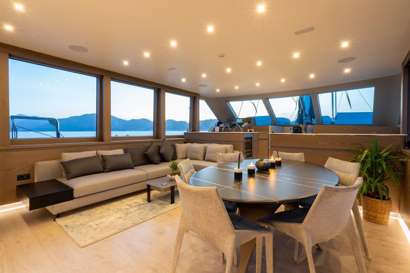 a living room with a table and chairs aboard PURA-VIDA Yacht for Sale