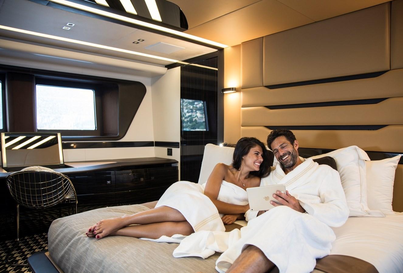 a man and a woman sitting on a couch aboard DYNAMIQ GTT 115  Yacht for Sale